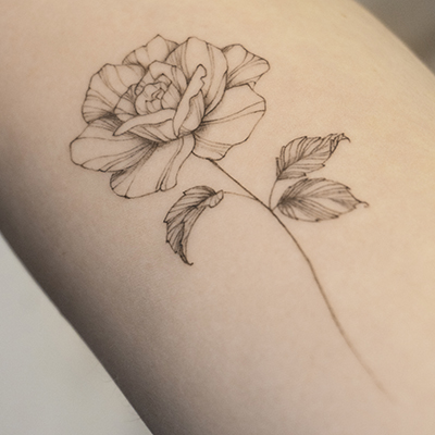 forearm fineline flower tattoo with rose from smasli ink an female tattoo artist working in salzburg austria
