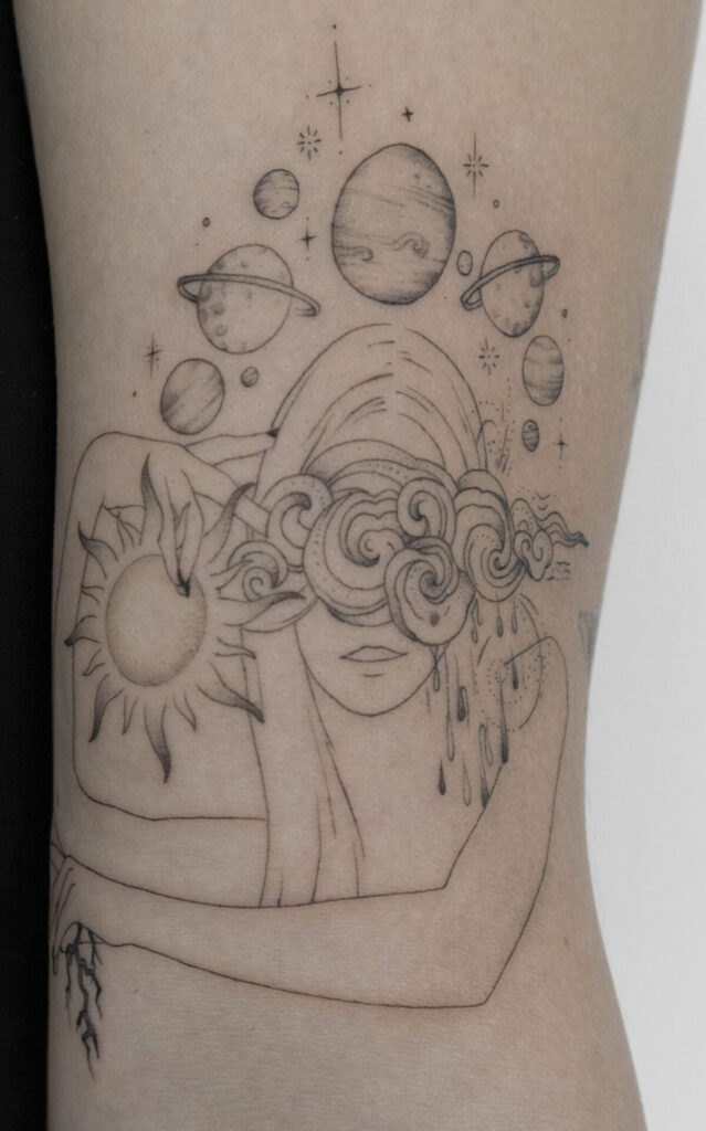 upper arm fineline tattoo with a woman and weather and the sun and moon and planed from smasli ink an female tattoo artist working in salzburg austria