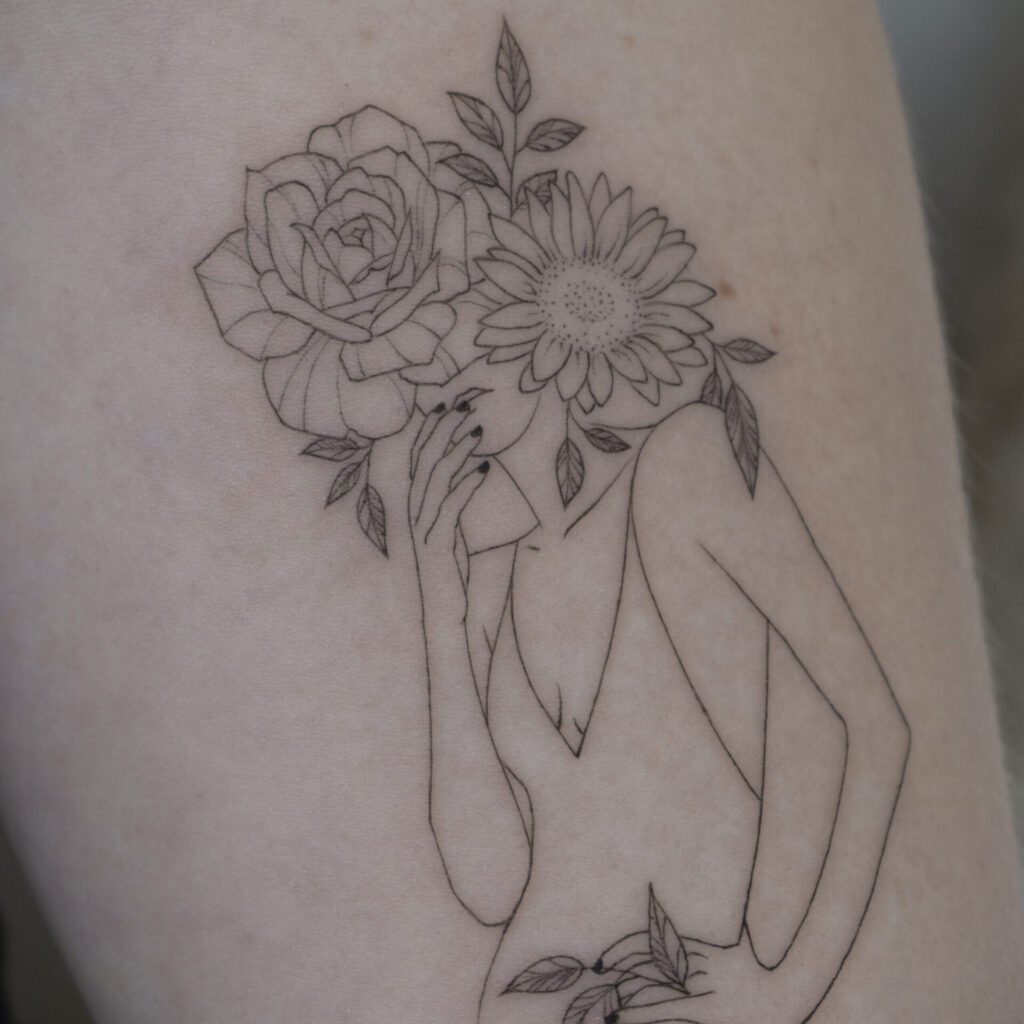 forearm fineline woman tattoo with flowers from smasli ink an female tattoo artist working in salzburg austria