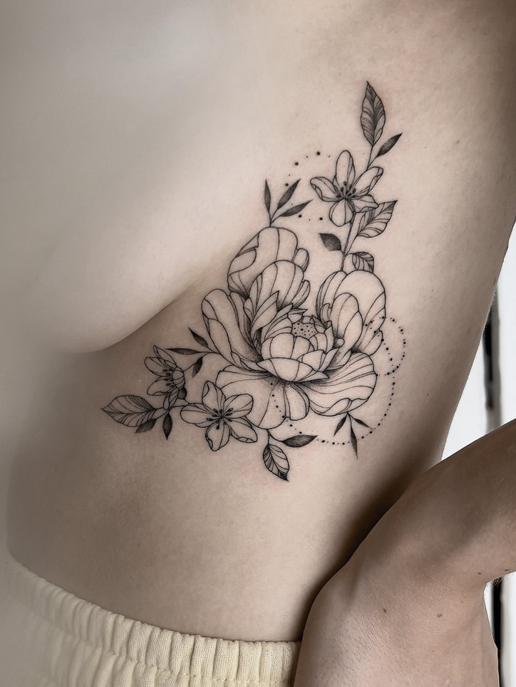 fineline flower tattoo on rip with a peony from smasli ink an female tattoo artist working in salzburg austria