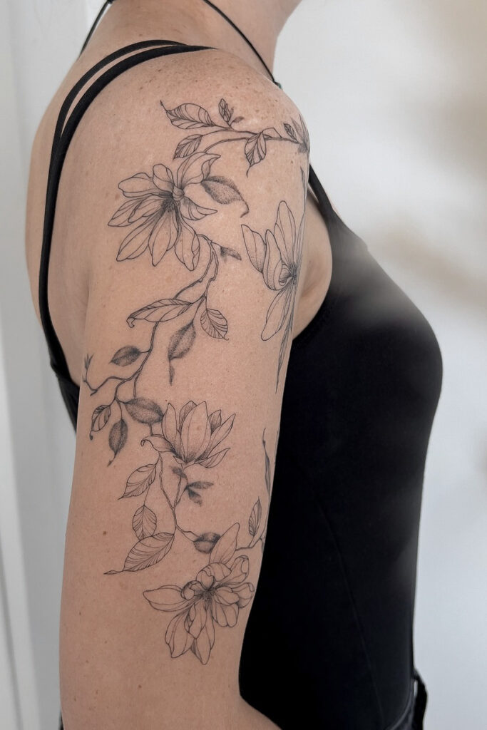 fineline flower scleeve with magnolia from smasli ink an female tattoo artist working in salzburg austria